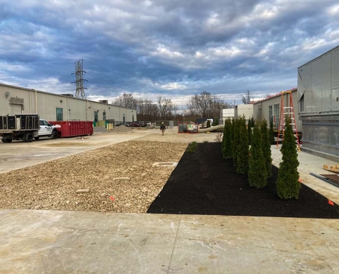 Mulch, gravel, and trees for a commercial landscaping project for ADM Flavors.